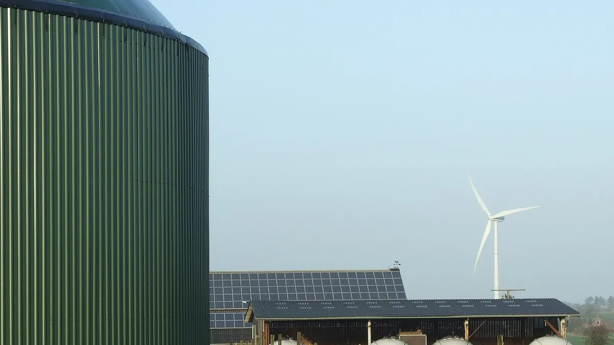 Symbolic image: biogas digester, wind turbine and solar panels on a farm in Horstedt, Schleswig-Holstein